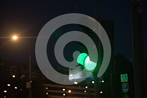 Traffic light, green light at night. Urban