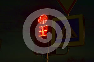 Traffic light at the intersection at night for pedestrians and cars