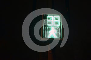 Traffic light at the intersection at night for pedestrians and cars