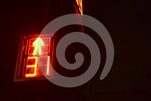 Traffic light at the intersection at night for pedestrians and cars