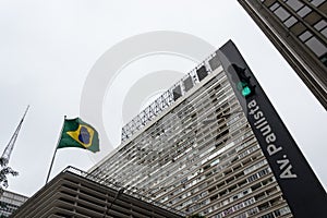 Traffic light in Paulista Avenue,  Conjunto Nacional Joint National modern multifunctional building in the background photo