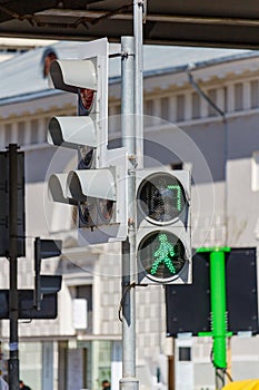 Traffic light with permissive green signal for pedestrians on the city street closeup photo