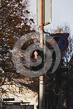 Traffic light with red light. A traffic light with a red human symbol that prohibits crossing the street. Soft focus photo