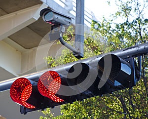 Traffic light in red with security cam