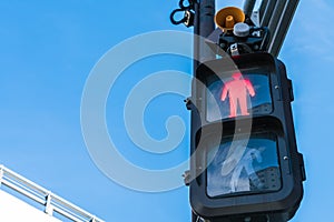 Traffic light with red sign for walkers to stop .