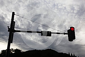 Traffic light on red in silhouette