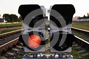Traffic light show red signal on a railway, close up