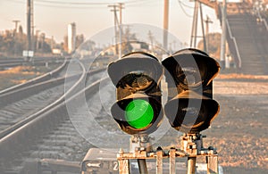 Traffic light shows green signal on railway