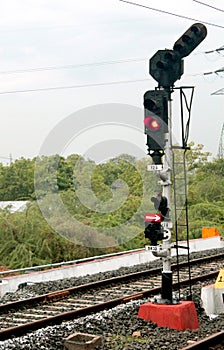 Traffic light shows red signal on railway.