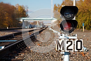 Traffic light shows red signal on railway.