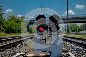 Traffic light shows red signal on railway. Red light. Railway tracks with red light semaphore