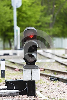 Traffic light shows red signal on railway. station.