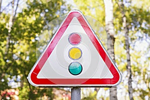 Traffic Light Sign selective focus.UK traffic light warning sign on deciduous sunny park in blur