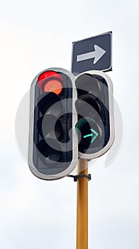 Traffic light, street and arrow with stop at intersection for directions for transportation, driving or downtown. Road