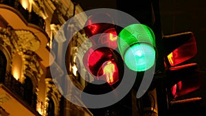 Traffic light switches from green to red in winter at night