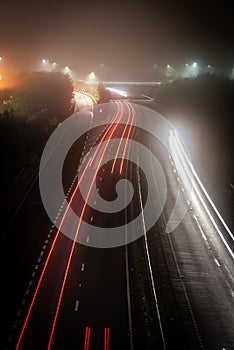 Traffic light trail on foggy night with long exposure, Brighton, East Sussex, UK