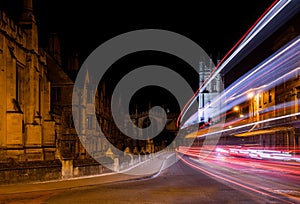 Traffic light trails past Oxford University college buildings on High Street