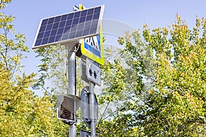 Traffic light working on solar power. Solar panel powering digital display