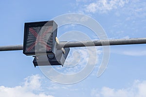 Traffic lights against a vibrant blue sky