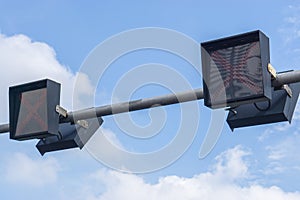 Traffic lights against a vibrant blue sky