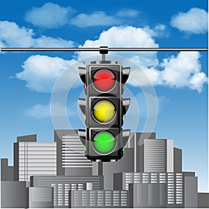 Traffic lights with all three colors on hanging against blue sky with clouds and cities buildings.