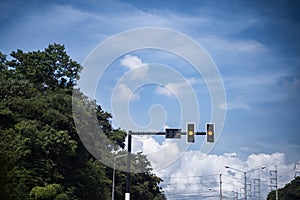 Traffic lights on the bright blue sky background