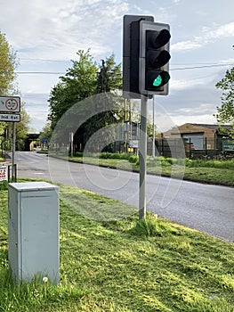 Traffic lights on green with the control box Circa May 2023