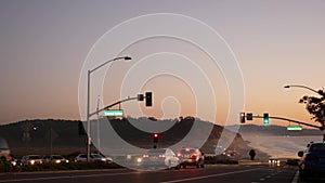 Traffic lights, pacific coast highway, California. Road trip along ocean in dusk