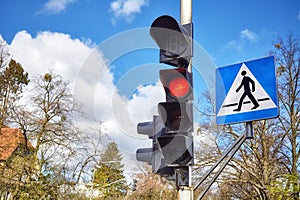 Traffic lights and pedestrian crossing sign in a city