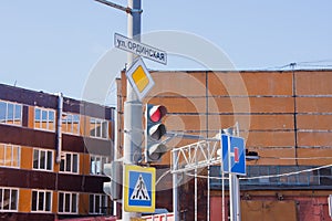 Traffic lights and road signs on a pole