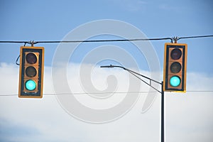 Traffic lights showing an green signal light.