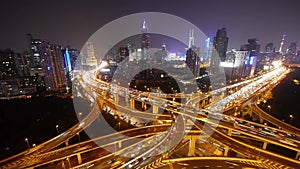 Traffic lights trail on overpass bridge at night,shanghai modern building.