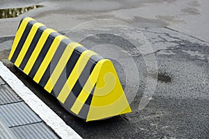 Traffic limiters in the Parking lot. Modern barrier fence for cars in summer Parking on the street