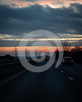 Traffic on the main highway through the landscape of SkÃ¥ne Scania in southern Sweden during a winter sunset