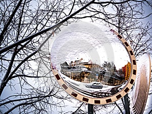 Traffic mirror partly covered with snow