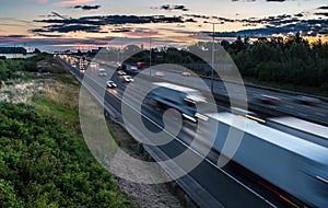 Traffic on the motorway at the dusk time