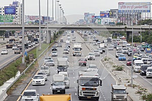 Traffic moves slowly along a busy road in Bangkok.