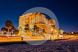 Traffic moving past a hotel and the beach at night, in Clearwater Beach, Florida.
