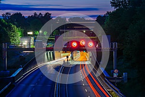 Traffic at night. Lights of the cars on the highway at the entrance to the tunnel. Highway road tunnel at night.