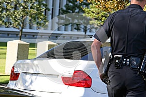 Traffic officer cautiously approaching stopped vehicle