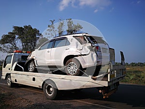 Traffic officers take towed car on tow truck. car is loaded into