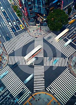 Traffic and people cross a busy intersection in Ginza