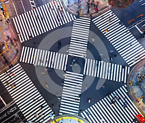 Traffic and people cross a busy intersection in Ginza