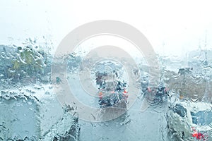 Traffic rain (focused on rain drops on glass)