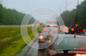 Traffic in rainy day with road car window with rain drops