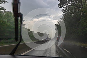 Traffic in rainy day with road view through car window with rain drops, blurry traffic on rainy day. Bucharest, Romania, 2020