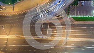 Traffic on the road in Jumeirah Lakes Towers district aerial night timelapse.