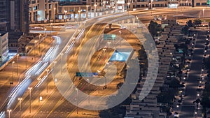 Traffic on the road in Jumeirah Lakes Towers district aerial night timelapse.