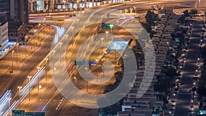 Traffic on the road in Jumeirah Lakes Towers district aerial night timelapse.