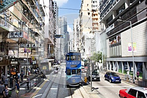 Thai woman walking go to bus station for passenger retro and vintage tram in Hong Kong, China